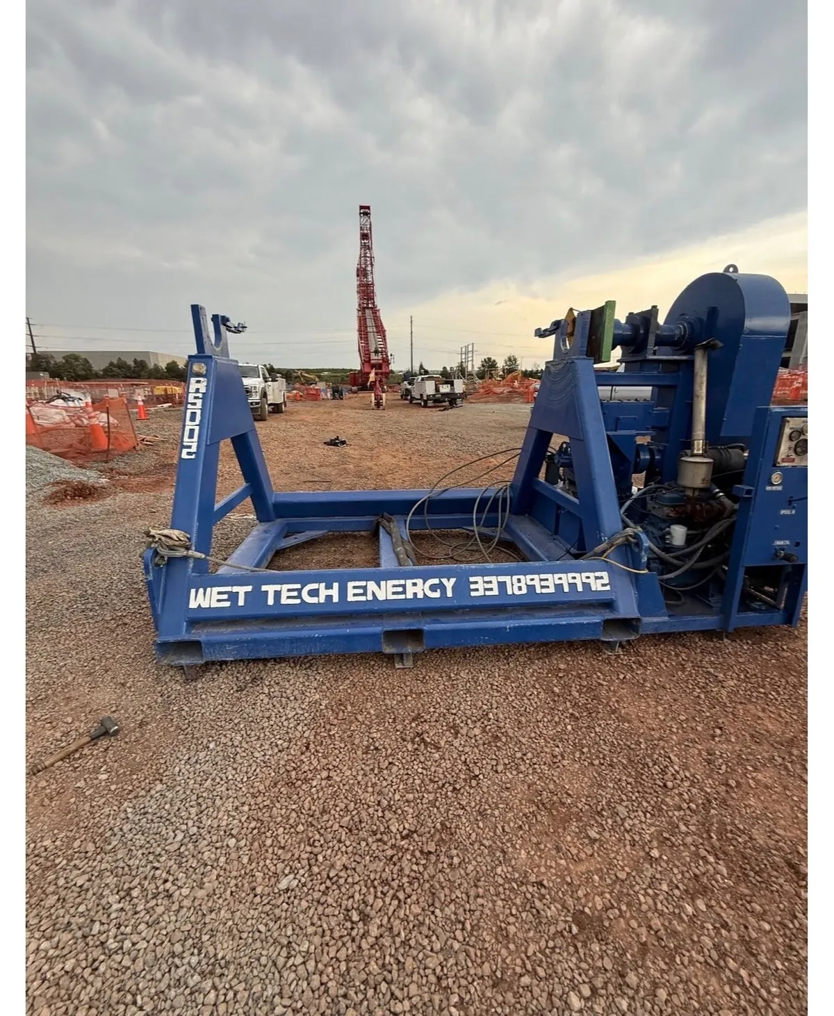 Wet Tech RS-002 spooling unit reel stand set up on gravel at a construction jobsite