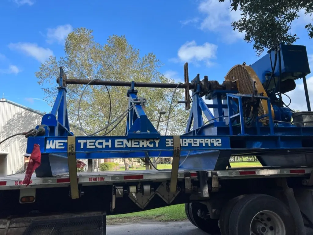 Wet Tech RS-005 wire rope spooling unit loaded on a flatbed trailer