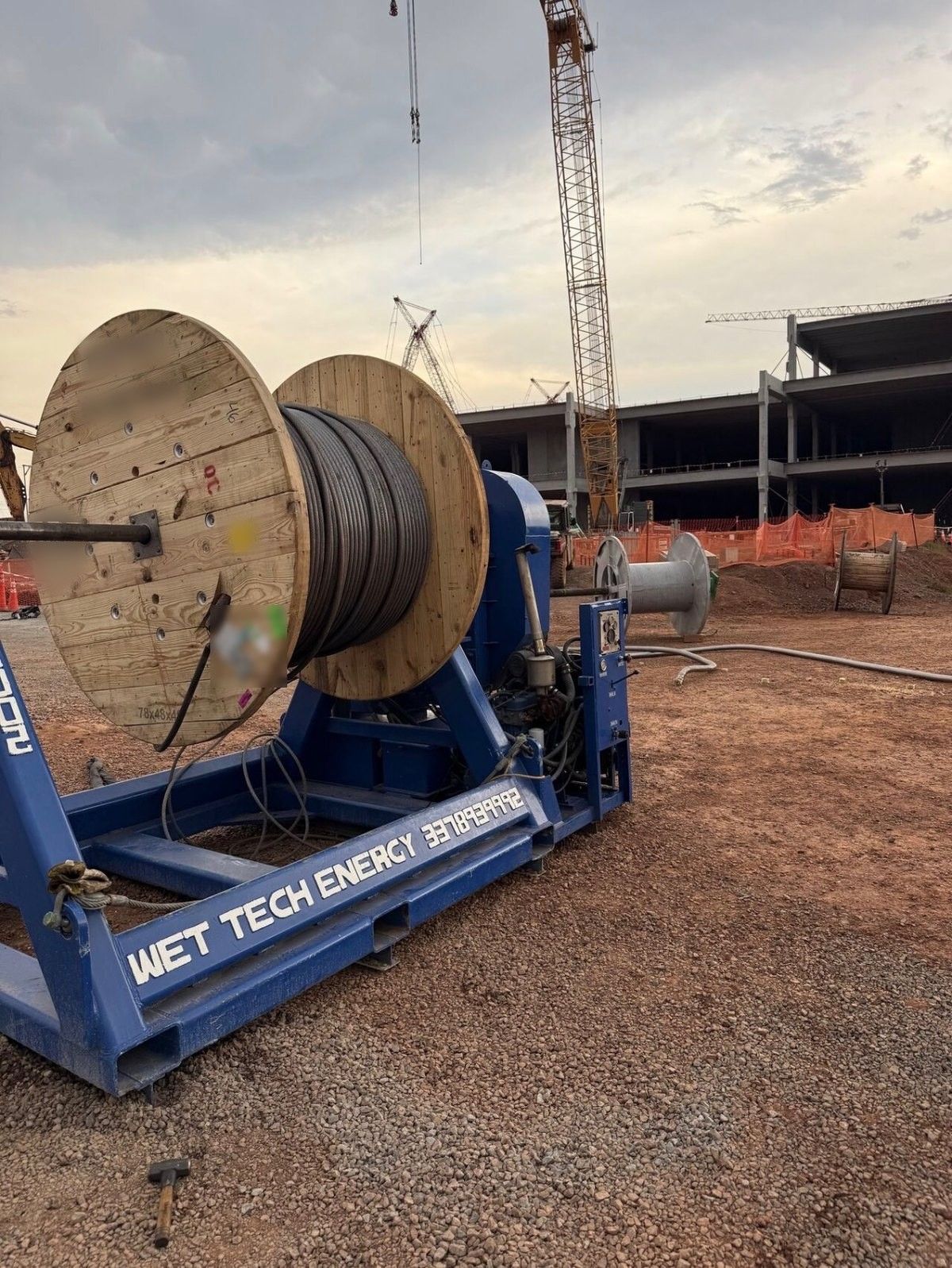 Wet Tech RS-002 spooling unit spooling a wooden reel on a construction jobsite
